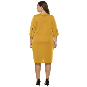 Close-up of mustard yellow dress back featuring intricate hollow-out floral lace sleeves