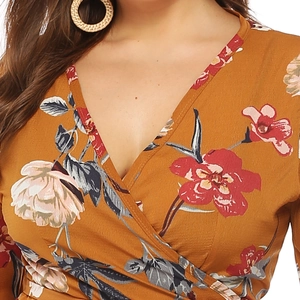 Detail of deep V-neck floral wrap dress in ginger yellow with ruffle and fabric texture