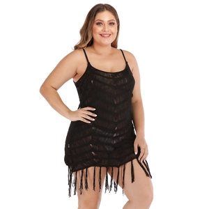 Detail of black plus size hollow knit beach dress featuring tiered fringe and tassels