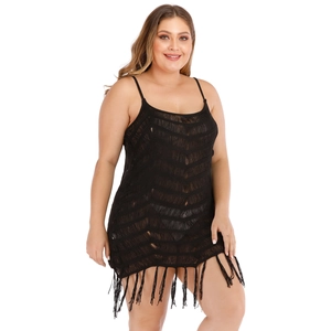 Detail of plus size black crochet beach dress featuring V-pattern texture and long fringe