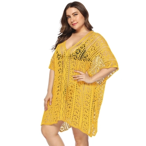 Close-up of yellow crochet beach cover-up featuring geometric hollow patterns and V-neck line