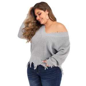 Detail of distressed ripped edges on a grey V-neck knitted sweater for women