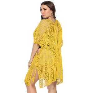 Detailed side view of yellow crochet beach cover-up featuring fringe ties and open slit