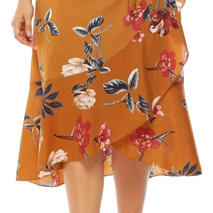 Detail of yellow floral skirt featuring irregular ruffled hem and chic bohemian print