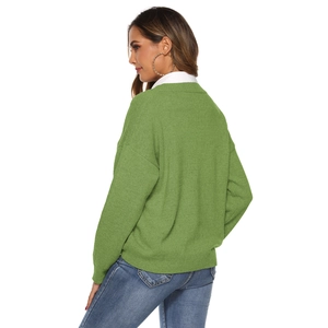 Detail of green knitted V-neck sweater with drop shoulder texture and layered collar