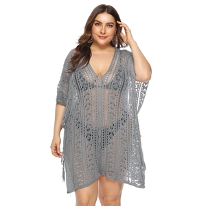 Detailed macro view of gray crochet lace pattern and V-neckline on plus size beach cover-up