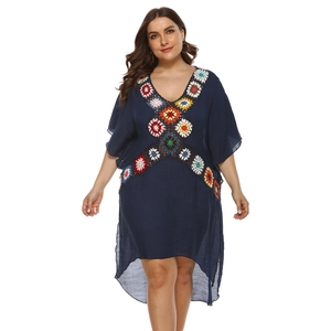 Detail of colorful crochet floral patchwork on V-neck dark blue boho beach dress