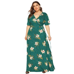 Detail of plus size wrap dress with green floral print and V-neckline on model
