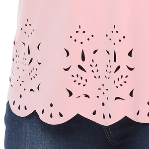 Detail of pink plus-size top featuring laser-cut hollow patterns and scalloped hemline