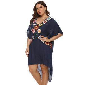 Detail of crochet floral pattern on V-neck dark blue oversized summer beach dress