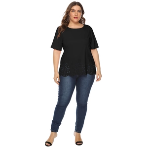 Detail of plus size black short sleeve top featuring intricate hollow out floral embroidery