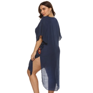 Detailed embroidery with vibrant floral patterns on blue sheer fabric side slit beach dress