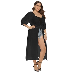 Detail showing textured lightweight fabric and adjustable waist drawstring on black cardigan