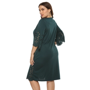 Deep green A-line dress with laser-cut floral hollow details and three-quarter sleeves