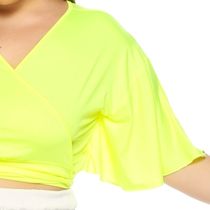 Detail of neon yellow V-neck wrap top showing ruffled sleeves and smooth elastic fabric