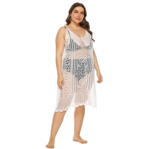 Detail of white crochet hollow-out dress showing knit mesh texture and geometric patterns