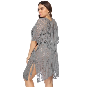 Detail of grey crochet texture with geometric hollow pattern and side slits on beach cover-up