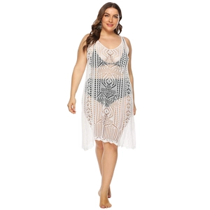 Detail of white crochet beach cover-up featuring geometric hollow out patterns