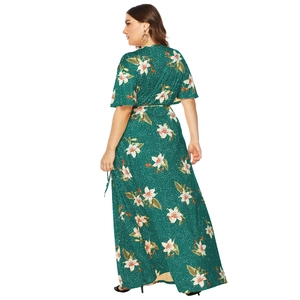 Detail of the back view of dark green plus size maxi dress with white lily floral patterns