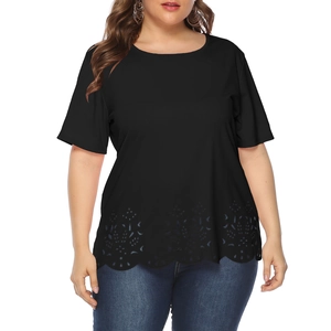 Detail of laser-cut floral eyelet patterns and scalloped hem on plus size black t-shirt