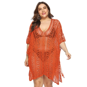 Detail of orange plus size crochet beach cover-up showing hollow knit V-neck texture