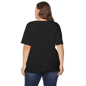 Rear view of a plus-size black short sleeve t-shirt with cut-out details on a model