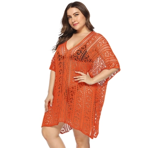 Close-up of bright orange crochet lace texture on a plus size V-neck beach cover-up