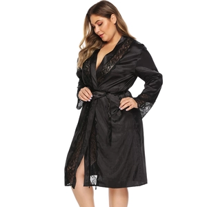 Close-up of silky black satin robe showing delicate lace trim on the sleeves and hem