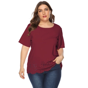 Detail of the laser-cut floral hem and scalloped edge on the burgundy plus size top