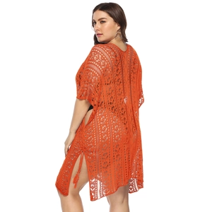 Detailed view of the bright orange crochet lace cover-up with geometric floral hollow pattern