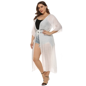 Close-up of crochet hollow lace waist and drawstring on white sheer beach cardigan