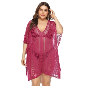Detail of hot pink V-neck crochet beach cover-up with intricate geometric openwork knit
