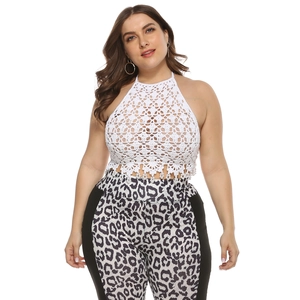 White crochet halter crop top with hollow floral patterns and bohemian tassel details