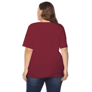 Back view of a plus-size woman wearing a burgundy short sleeve T-shirt with denim jeans