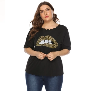 Close-up of black plus size top with scalloped edges and leopard print lip graphic