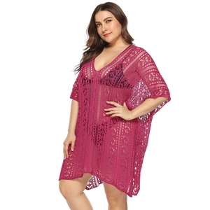 Detail of rose red crochet beach cover-up featuring intricate hollow knit patterns