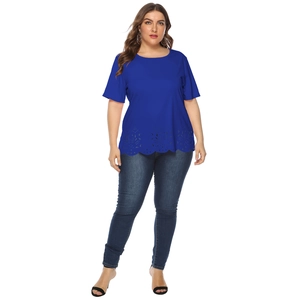 Detail of laser cut hollow pattern and wavy hem on a royal blue short sleeve top
