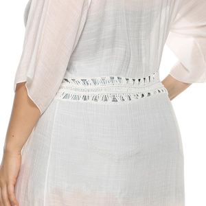 Detail of white sheer cardigan featuring wide crochet lace trim and vertical striped texture