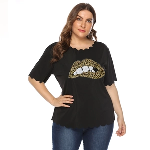 Detail of plus size black tee with leopard print lip applique and wavy scalloped edges