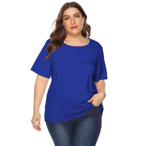 Detail of the blue plus size top featuring laser-cut floral patterns and scalloped hem