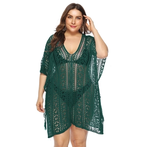 Detail of dark green crochet plus size beach cover-up with hollow knit and tassels