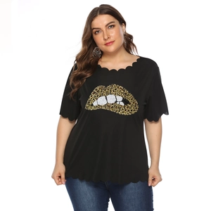 Detail of plus size black top featuring leopard print lips and scallop wave hemline