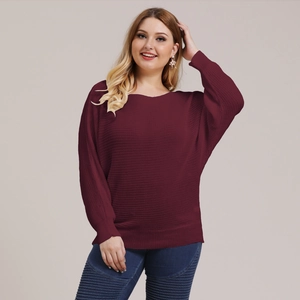Detail of burgundy batwing sleeve knit sweater paired with blue distressed denim jeans
