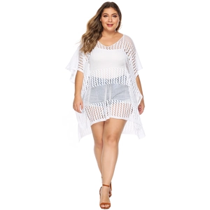 Detail of white hollow-out crochet knit beach cover-up with V-neck and batwing sleeves