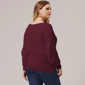 Detail view of burgundy knitted sweater with batwing sleeves and loose texture