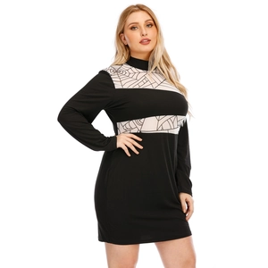 Detail view of plus size black mini dress with white spider web panels and mock neck