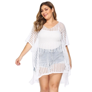 Detailed close-up of white honeycomb crochet knit texture on a loose V-neck beach cover-up