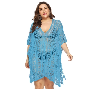 Detail of blue crochet hollow-out lace fabric and V-neckline of beach cover-up dress