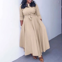Detail of high waist khaki maxi dress featuring an elegant flared hem and waist tie