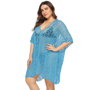 Detailed close-up of bright blue hollow crochet beach cover-up with V-neck and side slits